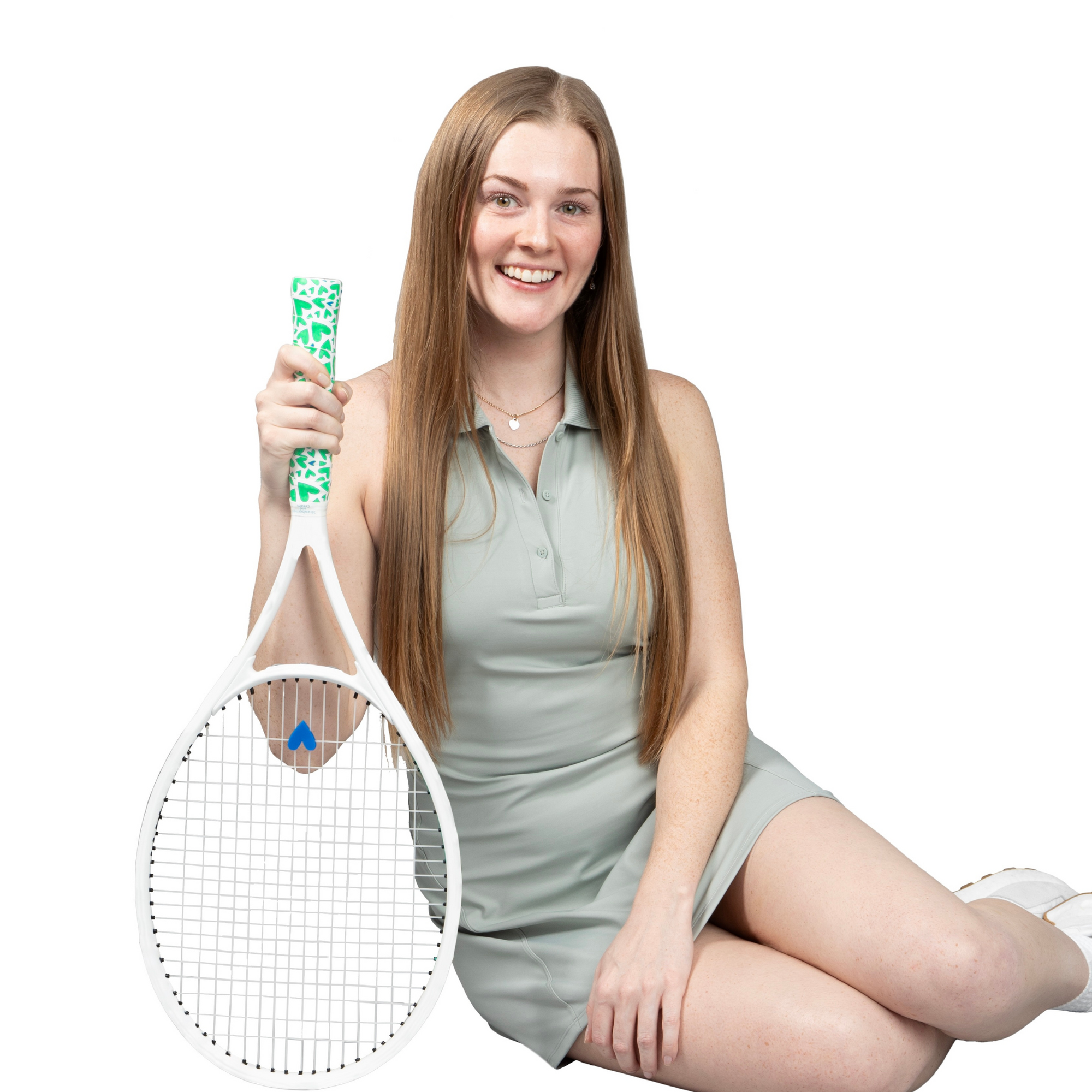 woman holding tennis racket with heart shaped tennis grip and matching dampener