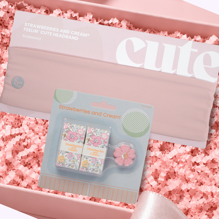 Strawberries and Cream Match Kit featuring a Rosewood pink tennis headband, floral overgrips, and matching flower dampener, displayed in a blush-pink gift box.