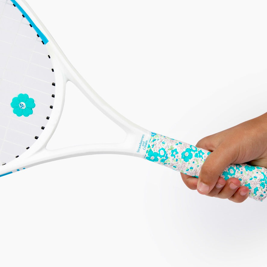 Hand holding racket adorned with The Anneliese Collection Matching Tennis Overgrip and Dampener - Turquoise