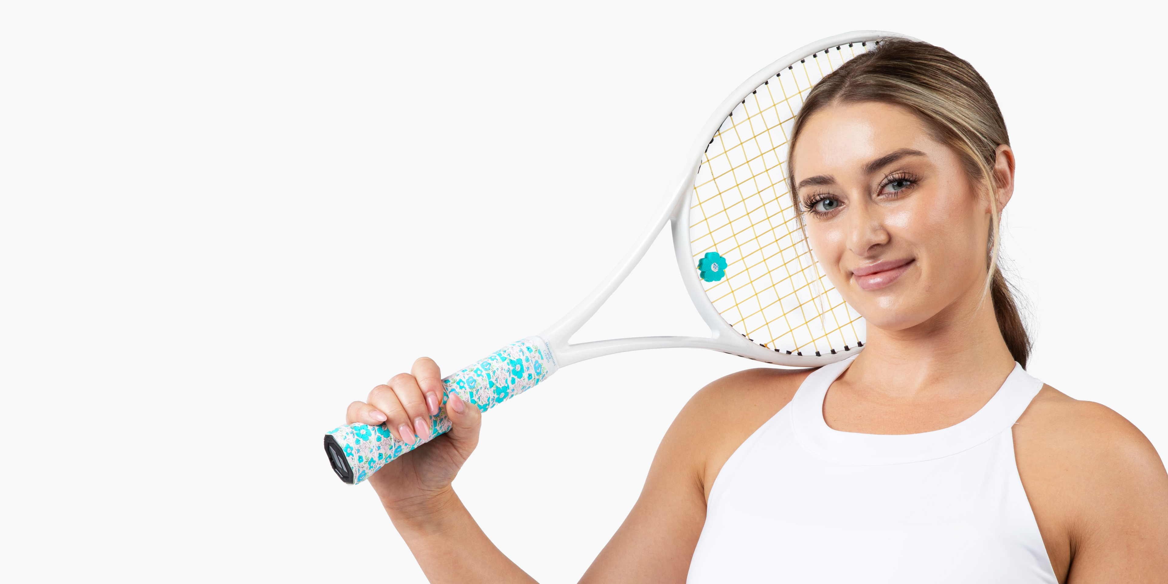 Beautiful lady holding a tennis racket adorned with The Anneliese Collection matching overgrip and dampener - Turquoise