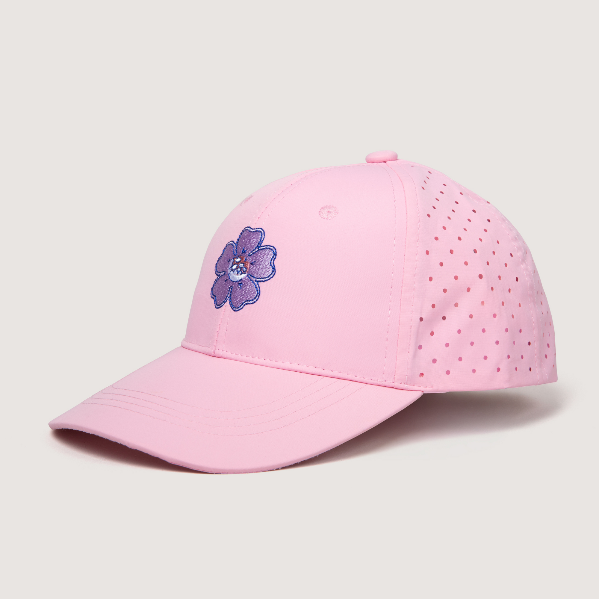 Pink baseball cap with a purple flower design on a light gray background