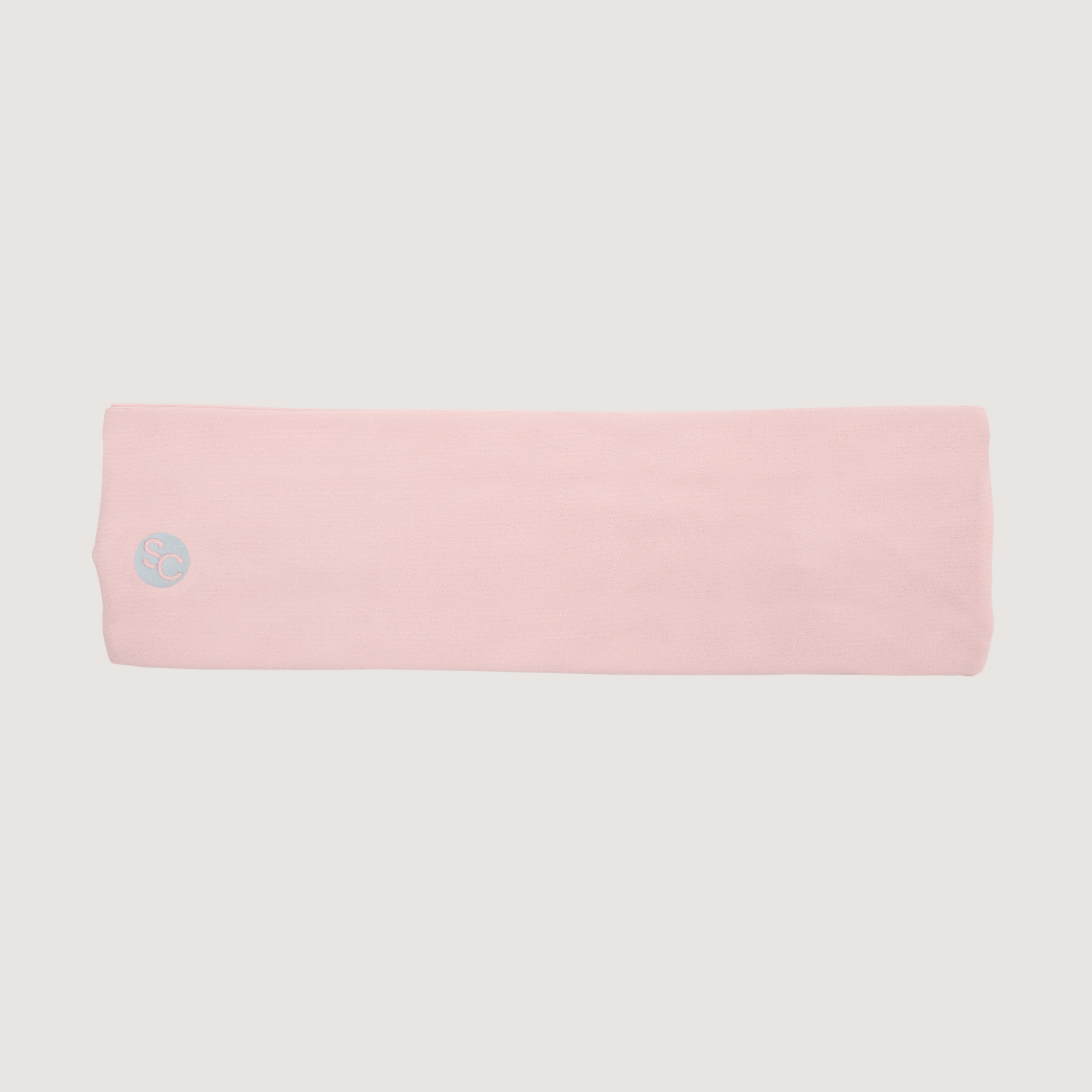 Pink headband with a small Strawberries and Cream logo on a light gray background